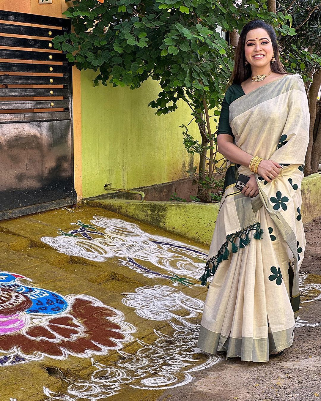 Green flower embro golden tissue saree with tussles.