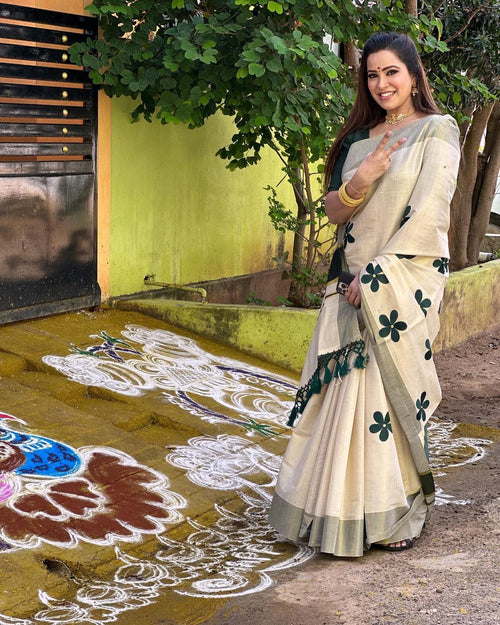 Green flower embro golden tissue saree with tussles.
